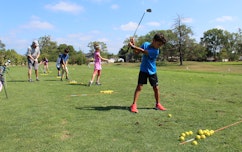 Young golfers practice their swings..