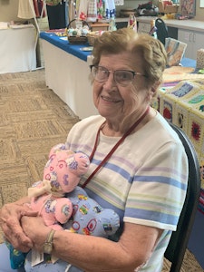 East Wing Volunteer Martha Demko holds some of the teddy bears she made.